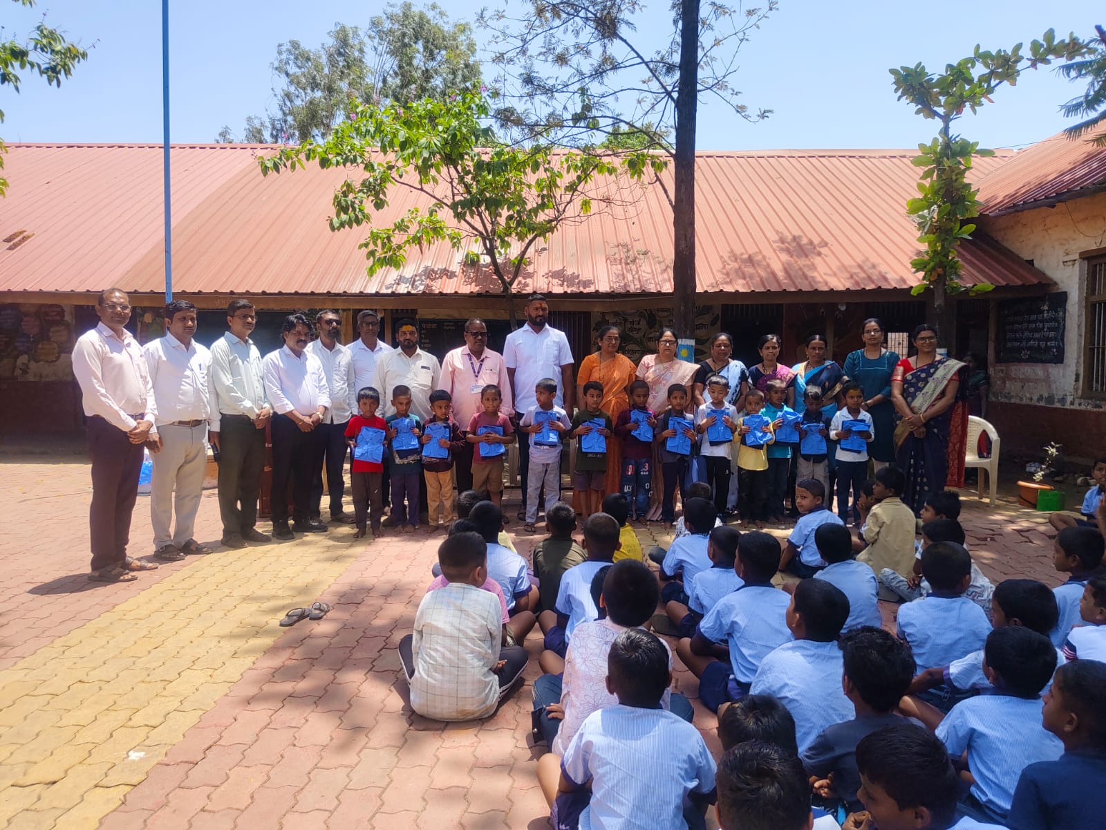 Distribution of Books, School Bags, Notebooks, Pens and Shoes to Children